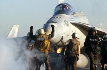 File:US Navy 030228-N-1810F-011 An aircraft director signals an F-A ...