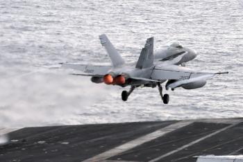 A Jet Launching Off the Flight Deck of an Aircraft Carrier in a ...