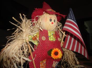 American flag with scarecrow