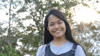 Teen asian girl smiling and looking at camera,slow motion Stock ...