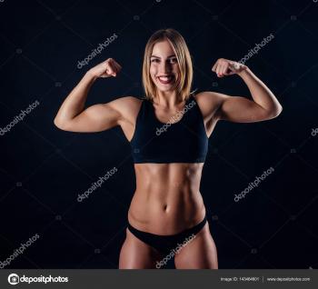 Sporty girl with great muscles in black sportswear. Tanned young ...
