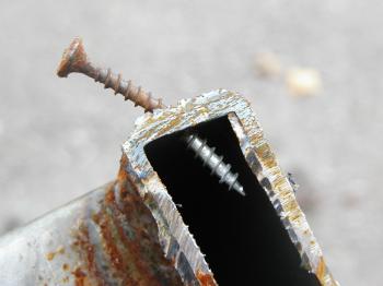 Bent screw in metal