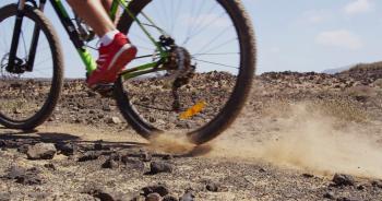 Mountain biking MTB cyclist braking hard locking brakes while ...