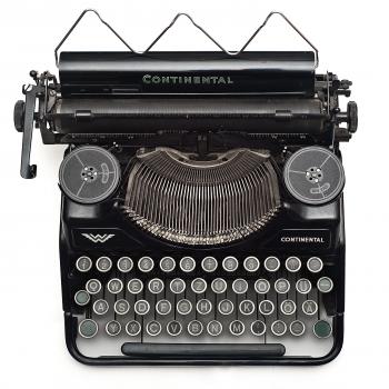 Black Continental Typewriter on White Surface