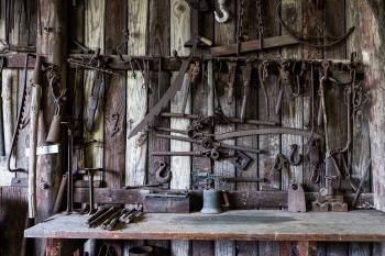 Black Metal Tools Hanged on a Rack Near Table
