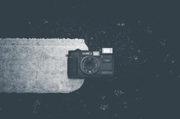 Blakc Camera on White Textile