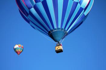 Blue and Teal Hot Air Balloon Near Pink and Blue Hot Air Balloon