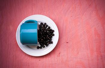 Blue Ceramic Tea Cup With Beans on Plate