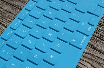 Blue Computer Keyboard on Gray Wooden Surface