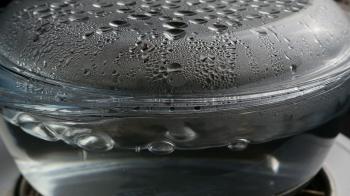 boiling water in transparent glass saucepan with condensation Stock ...