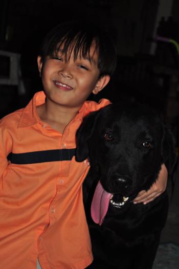 Boy and black Labrador