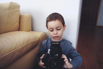 Boy Holding Black Dslr Camera