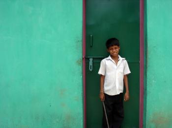 Boy infront of green door
