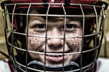 Boy With a Football Helmet Smiling