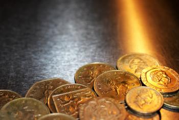 British pound coins on metal background