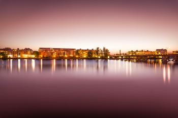 Brown Lighted Buildings Near the Body of Water Landscape Photo