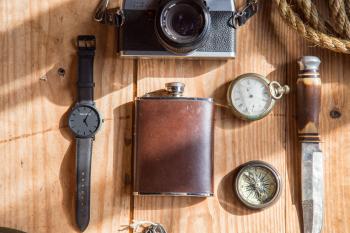 Brown Wine Flask Near Lomo Camera Watch Knife and Pocket Watches on Able