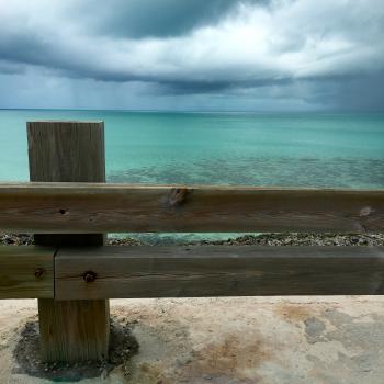 Brown Wooden Fence Near Blue Ocean Water Under White Cloudy Sky during Daytime