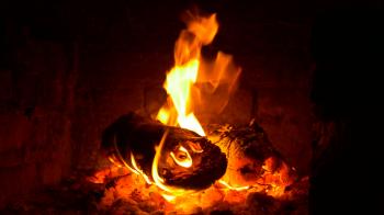 Flames of fire in fireplace in evening time 4K. Burning firewood ...