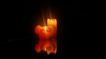 Two burning candles reflected on the mirror surface Stock Video ...