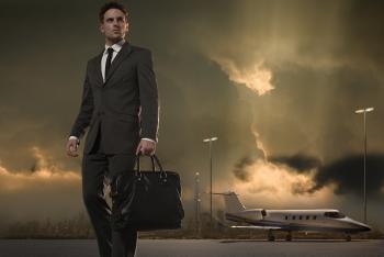 Kronwell | Businessman walking across tarmac