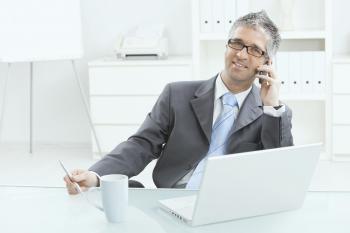 Businessman working at desk - Skyline Entourage | Montreal