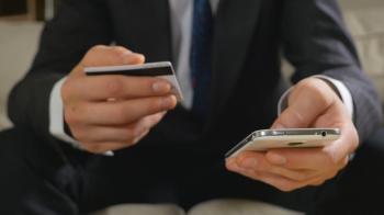 Young businessman paying with credit card on a smart phone Stock ...