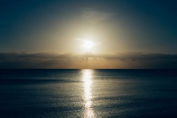 Calm Sea With Sun Setting Photo