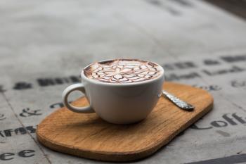 Cappuccino in Ceramic Teacup Beside Teaspoon