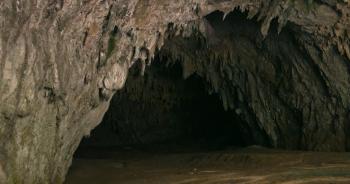 Inside cave stone wall dark light background. Cavern entrance. Cave ...