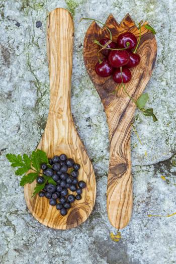 Cherries and blueberries in wooden spoon