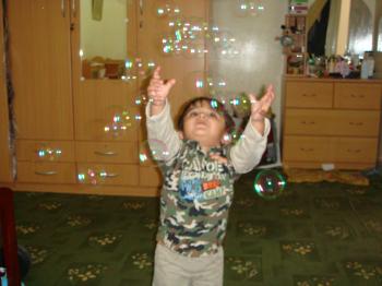 Child chasing bubbles