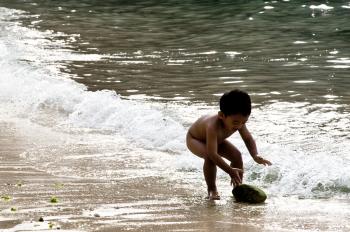 Child playing in ocean
