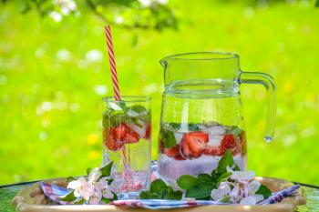 Clear Glass Pitcher With Water and Strawberry