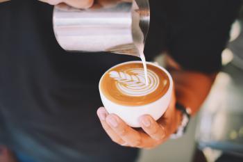 Close-up of Hand Holding Cappuccino