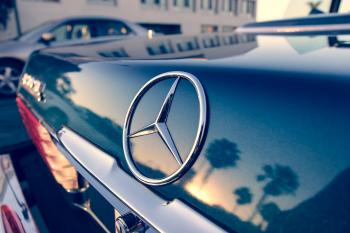 Close Up Photography of Chrome Mercedes-benz Car Emblem