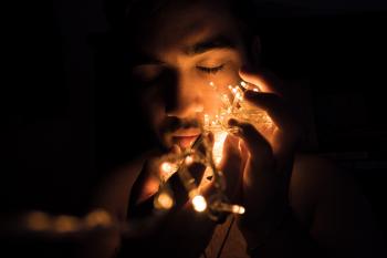 Close-up Photography of Man Holding Christmas Lights