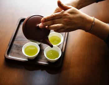 Close-up Photography of Teapot Pouring Tea