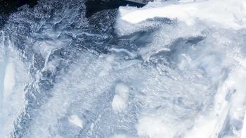 Water flowing under transparent ice surface. Ice background. Ice ...
