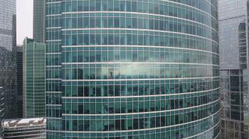 Skyscrapers. Office windows with city reflected in it. Nobody. Close ...