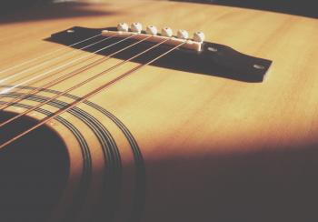 Closeup Photo of Acoustic Guitar Body and String