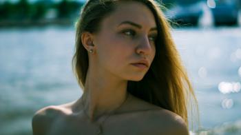 Closeup Photography of Woman With Gold Necklace Near Body of Water during Daytime