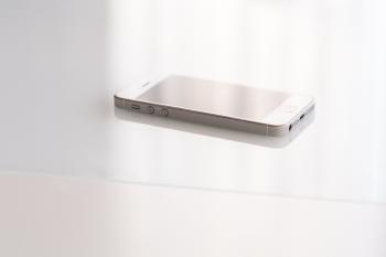 Closeup view of white smart phone. Connectors details.