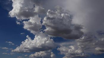 Dramatic White Fluffy Puffs Swirl In Blue Sky Until Dark Storm ...