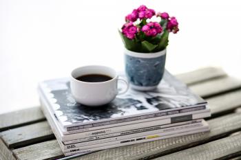 Coffee and flowers sitting on a stack of books image - Free stock ...