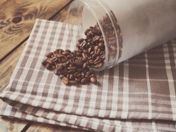 Coffee Beans Spilled on Gray and White Plaid Textile
