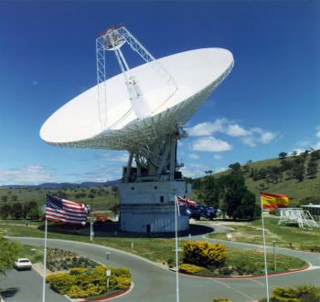 View of Canberra 70m (230 ft.) antenna with flags from the three ...