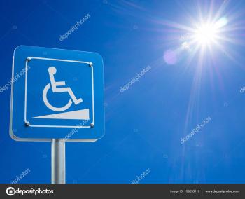 Disabled parking space and wheelchair way sign and symbols on a pole ...