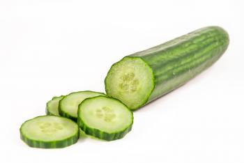 Cucumber and slices isolated over white