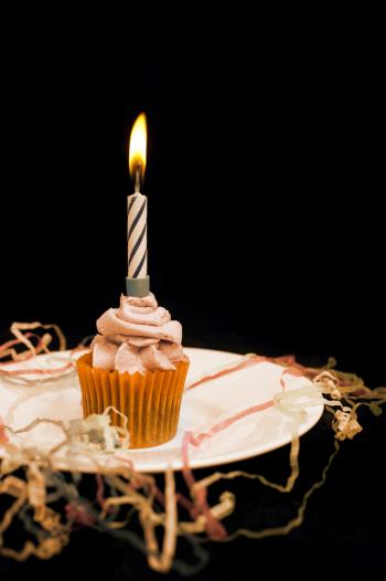 Cupcake with burning candle